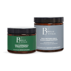 Two amber Belle Vitale supplement jars with black lids on a black background. 